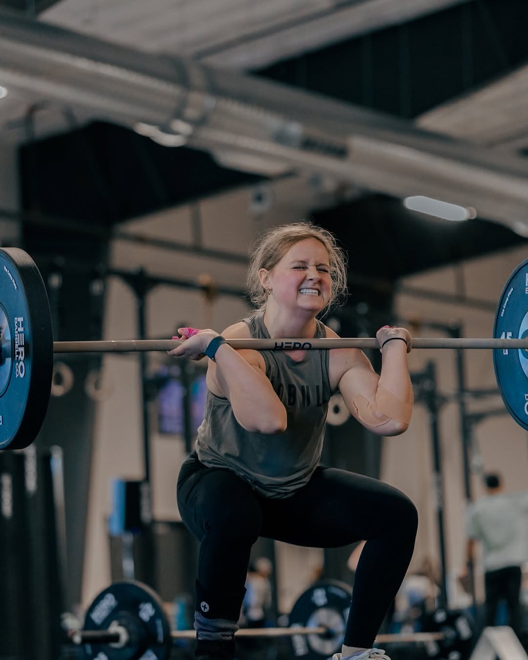 Athlete performing squats with barbell