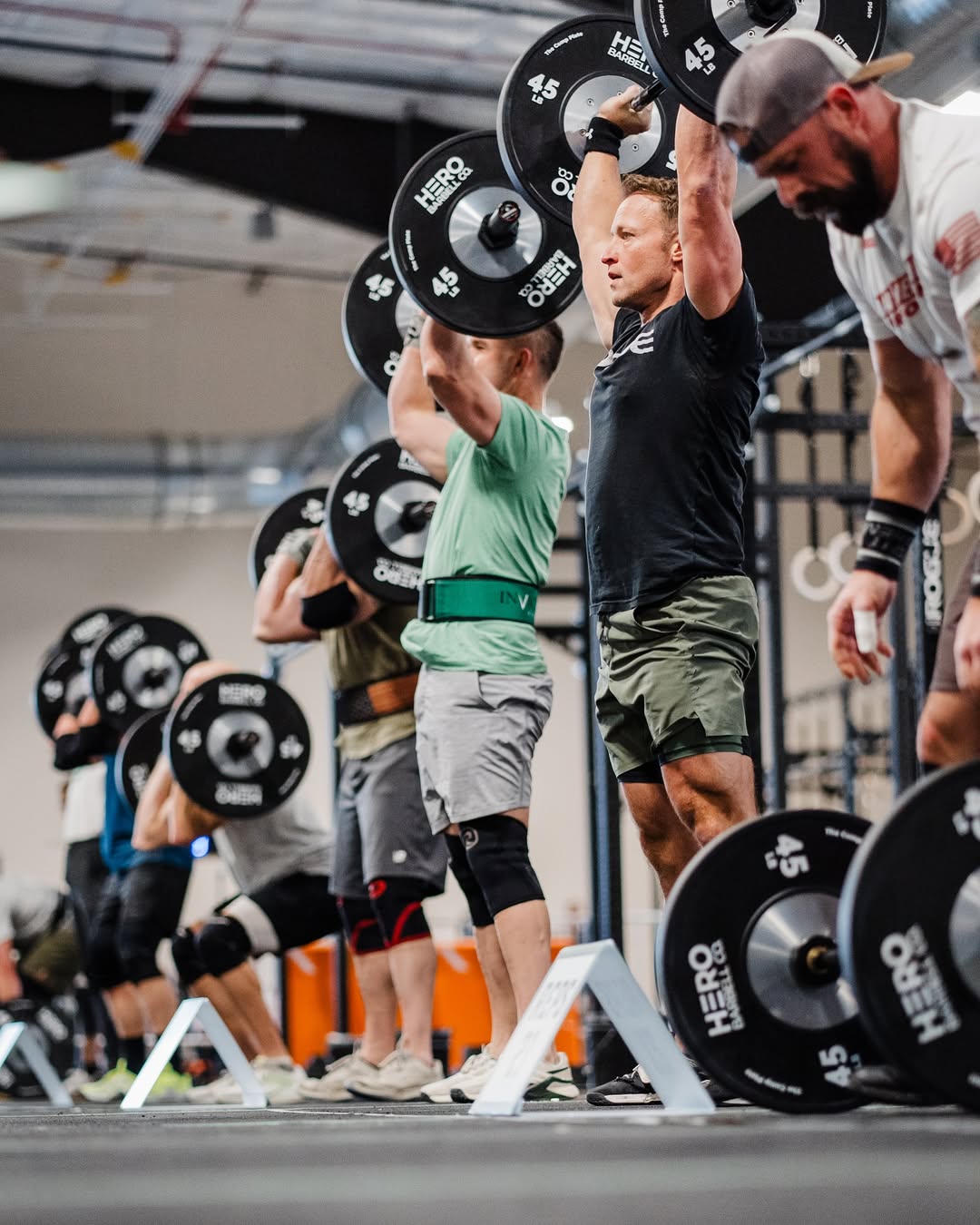 Athlete executing thrusters in competition